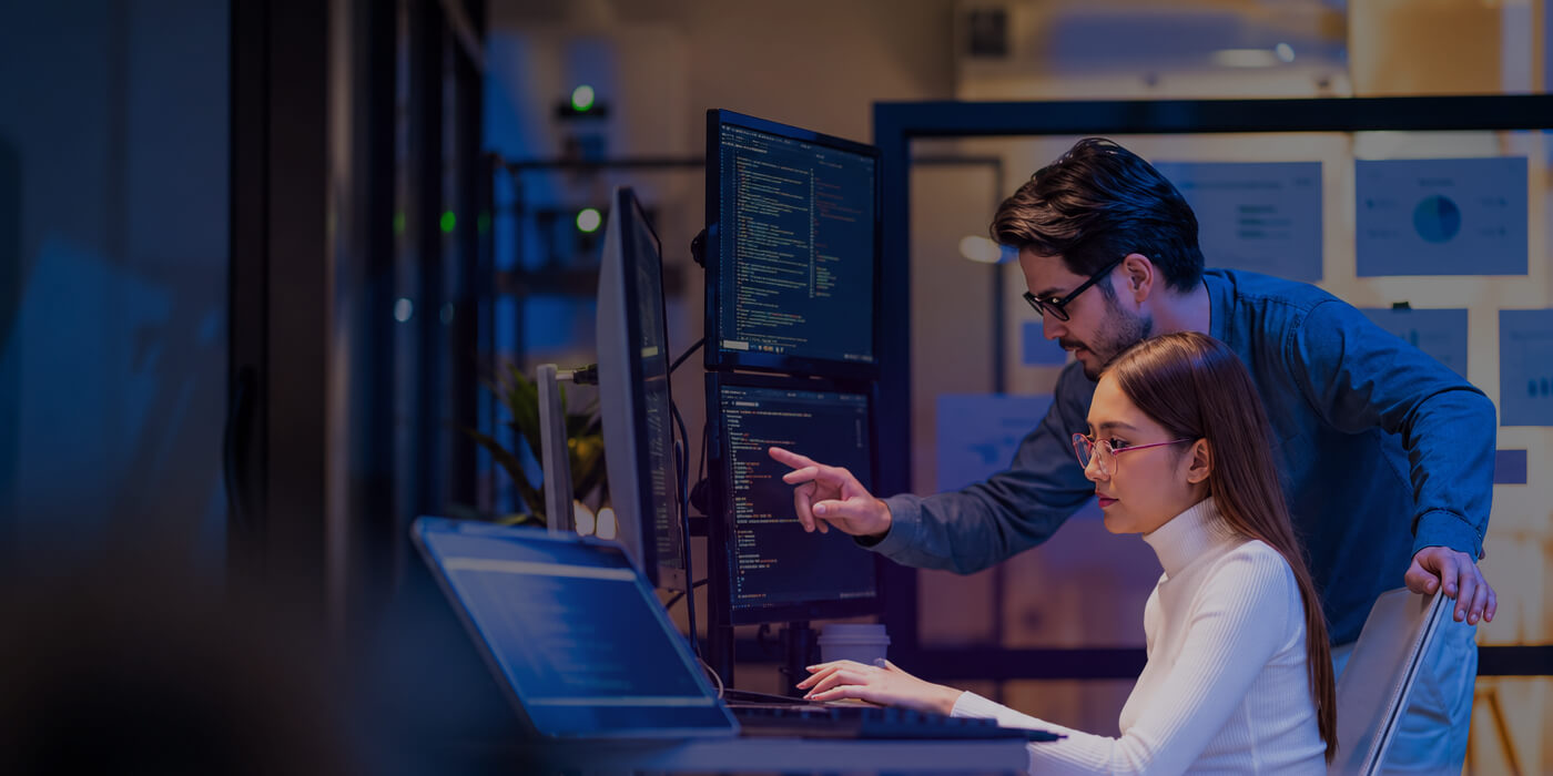 Cybersecurity analysts reviewing threat data on monitors in a security operations center